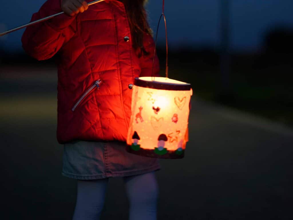 portrait of little girl with lighted paper lantern
